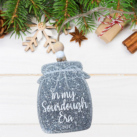 Sourdough starter jar Christmas ornament on silver glittery acrylic with 'In My Sourdough Era' hand-painted in white