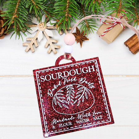 Sourdough Baked Fresh Daily Christmas ornament on red glittery acrylic, hand-painted with white text