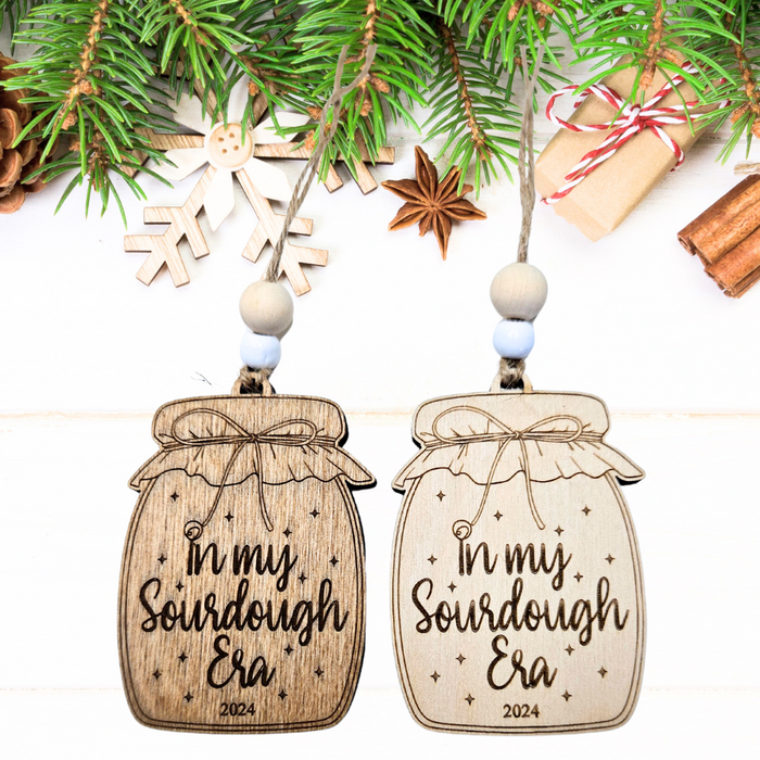 Are you in your sourdough era? Prove it with this sourdough starter jar Christmas ornament! Cut from 1/4" thick Baltic Birch, this ornament is shaped like a classic starter jar and features the phrase "In My Sourdough Era 2024" laser engraved into the wood.